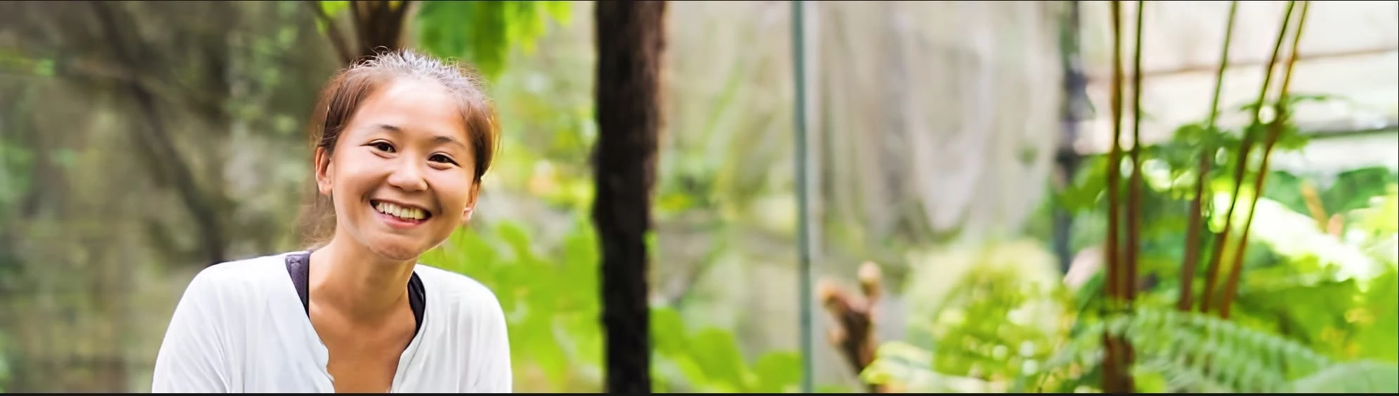 A smiling gardener in the greenhouse