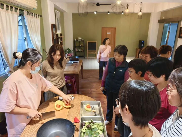 Retreat participants preparing food together around the kitchen counter